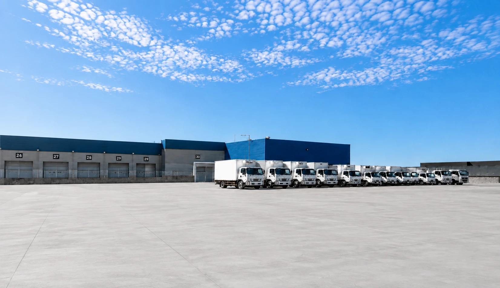 Flota de PFC Transportes estacionada frente a los andenes del centro de distribución